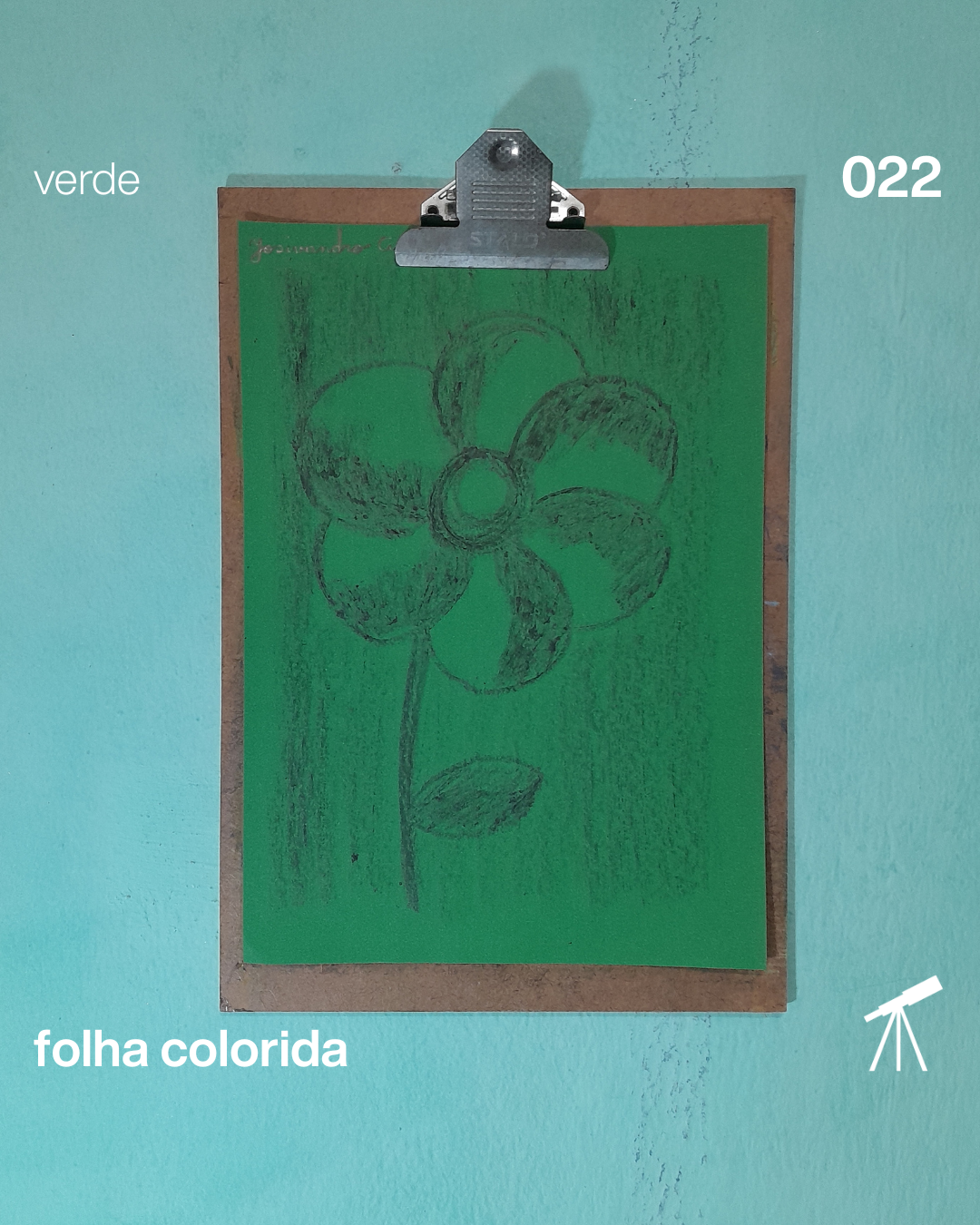 #FolhaVerde 022 - Flor do dia 1 Flor do dia, desenhada com giz de cera de cor preta sobre uma folha de cor verde.
